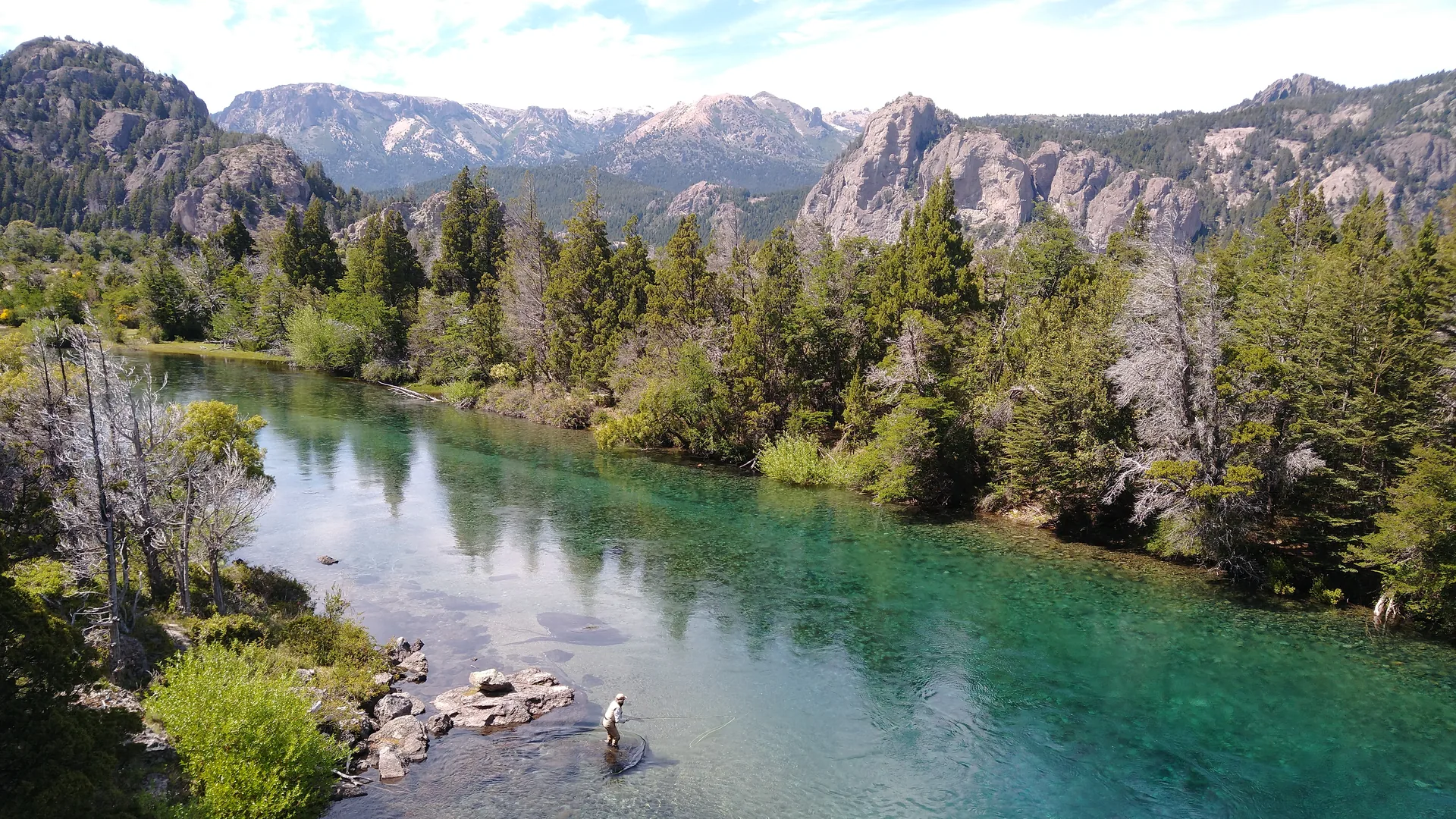 Fly fishing the clear Traful River beneath the Andes near Bariloche, Patagonia