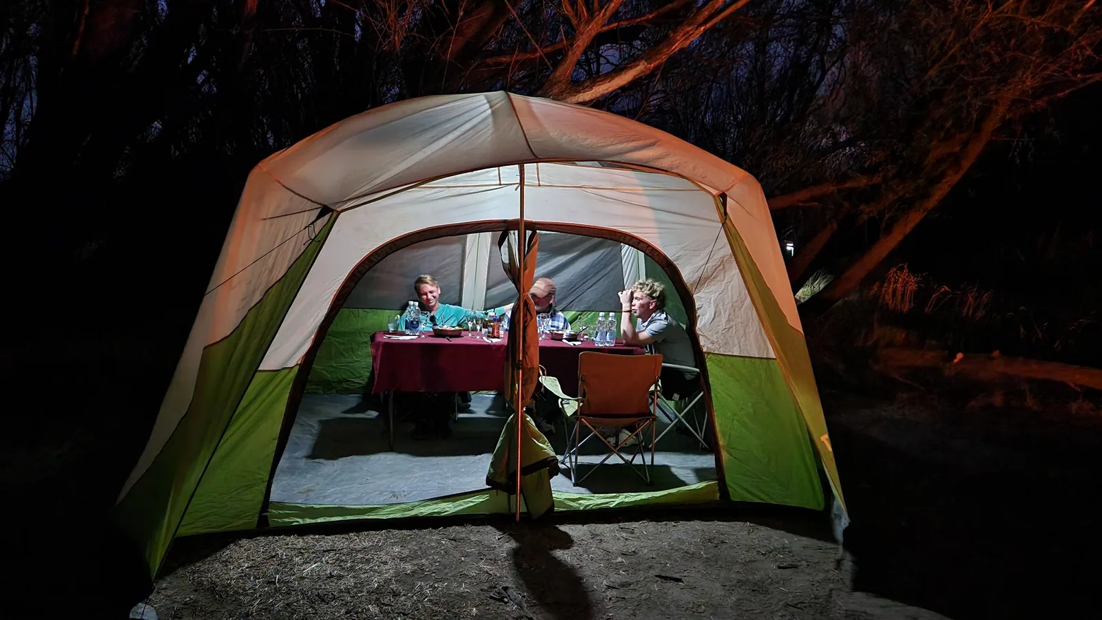 Guests dining inside a tent at a Patagonia fly fishing camp