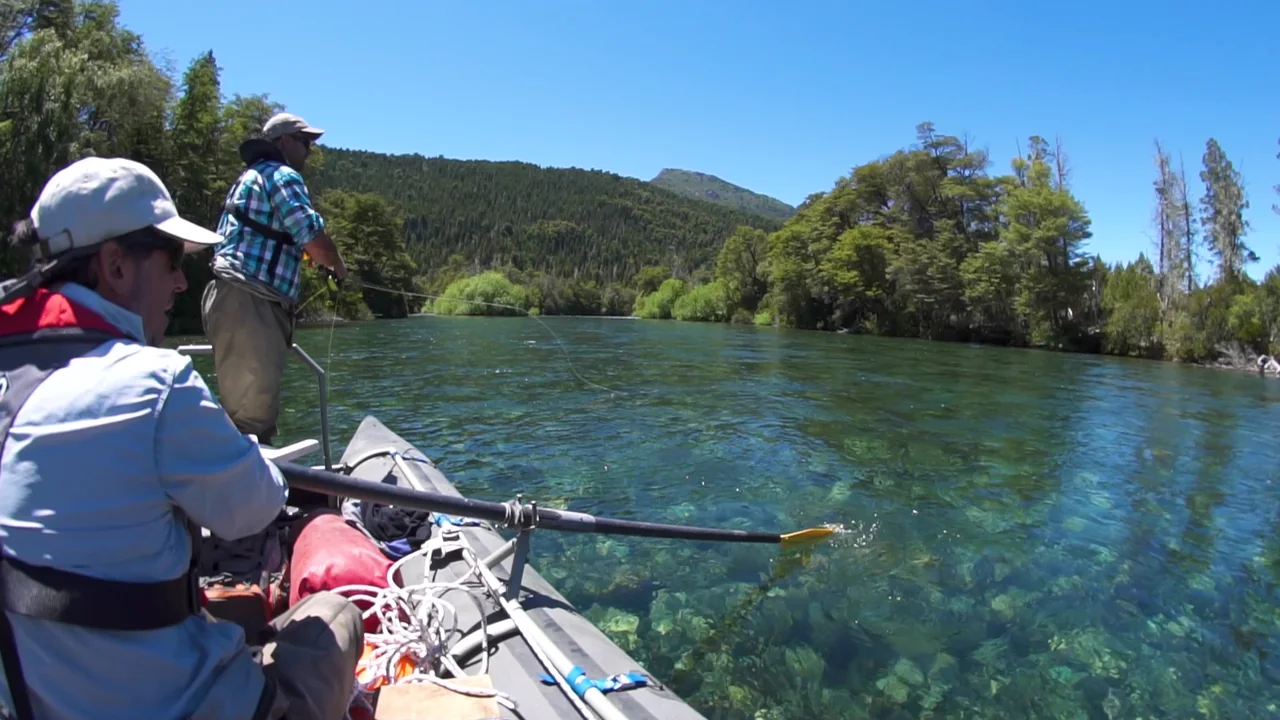 Anglers fly fishing from a drift boat on the clear Manso River near Bariloche, Patagonia