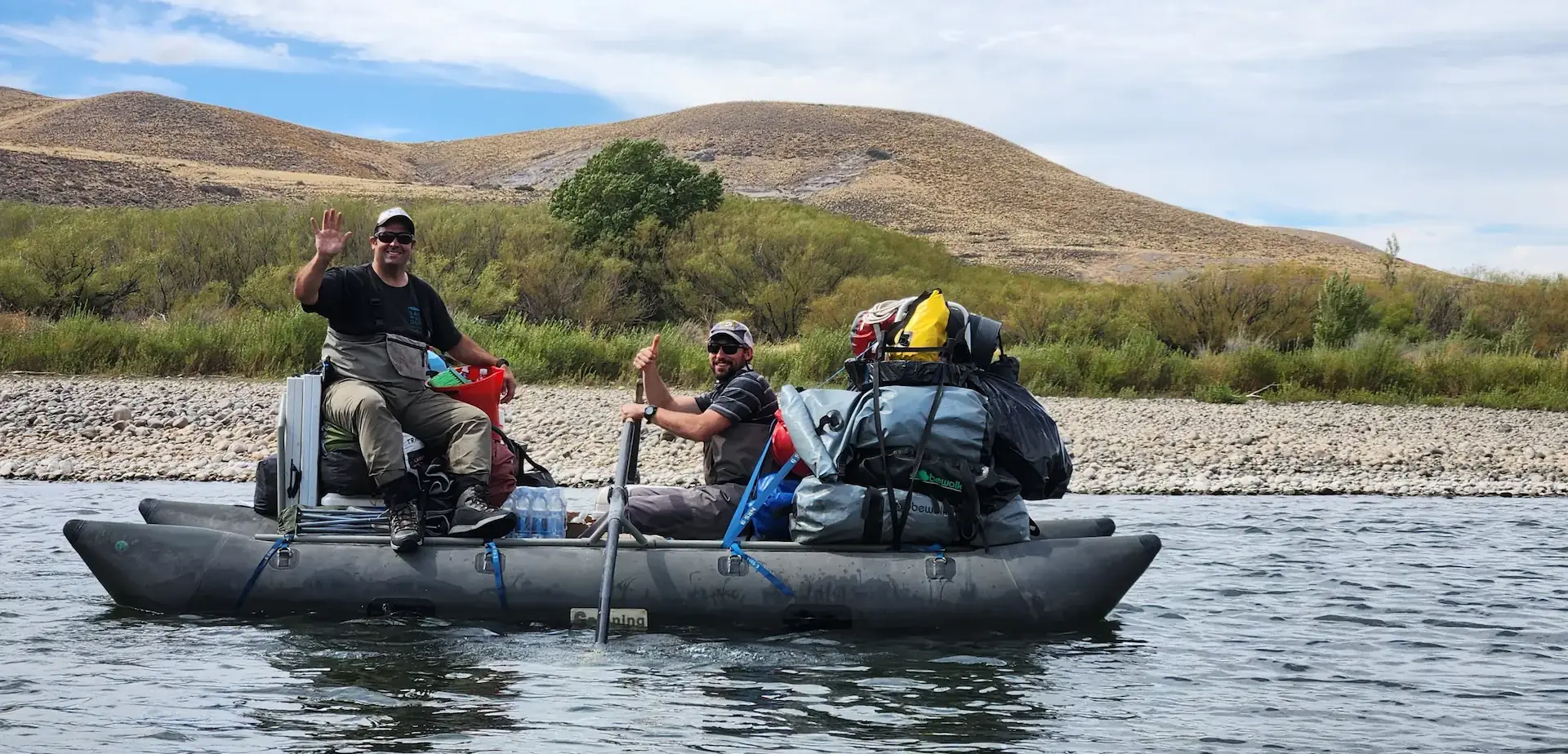 Fly fishing camp in Bariloche, Patagonia — assistant floating the cargo boat on Caleufú River